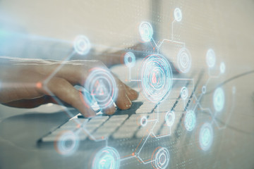 Double exposure of data internet theme hologram with man working on computer on background. Concept of innovation.