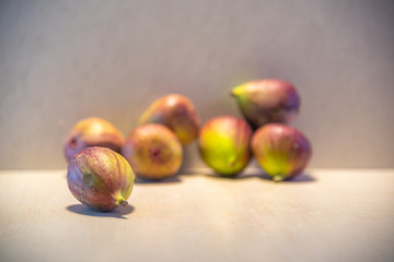 Fresh figs (Ficus carica L.) on lighted background
