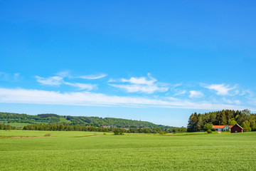 Cultivated land with a farm at a field