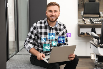 Young man using laptop in barber shop. Online shopping