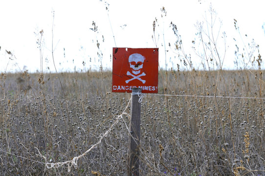 Sign Danger Mines for minefields on the field near the border crossing point Chaplynka, Khersonskaya oblast, Ukraine