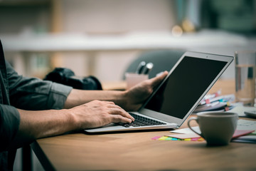 Professional journalist working with laptop in office, closeup