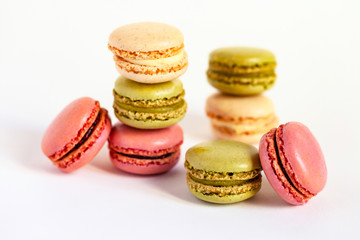 Assortment of delicious traditional french macaroons. Colorful sweet dessert for real gourmands. White background, copy space, close up, macro.