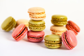 Assortment of delicious traditional french macaroons. Colorful sweet dessert for real gourmands. White background, copy space, close up, macro.