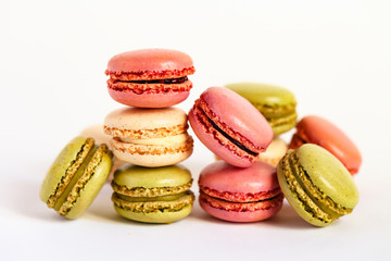 Assortment of delicious traditional french macaroons. Colorful sweet dessert for real gourmands. White background, copy space, close up, macro.