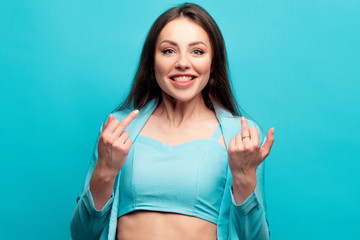 Beautiful and positive brunette in blue on a blue background. Stylish bright image in shades of turquoise.