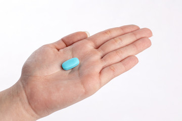 Blue vitamine in hand. medicines and vitamins