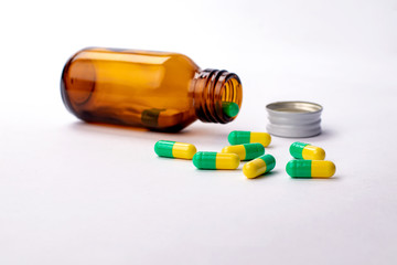 Glass bottle with medicines and vitamins outside. Cap bottle out