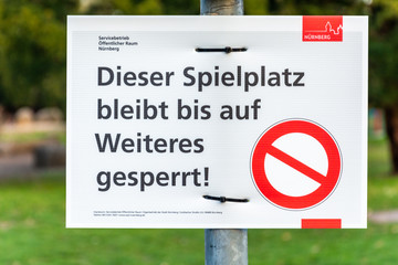 NUERNBERG, GERMANY - March 27, 2020: Sign in German about a closed playground due to the Corona...