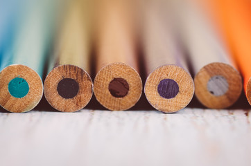 Back to school and offices stationary concept, stack of color pencils  on wooden desk