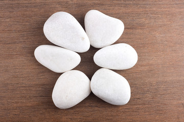 Fototapeta na wymiar White stones on wooden background
