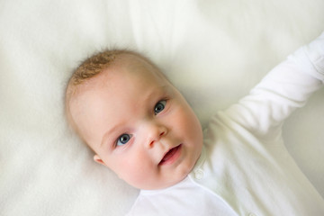 Cute adorable baby child. Happy baby girl on white background and looking at the camera.