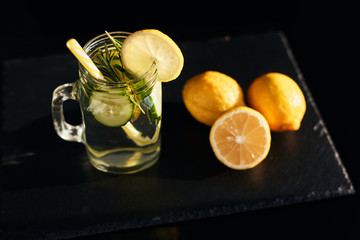 Lemonade on a dark background. Summer refreshing drink. View from above.