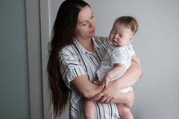 Pretty woman holding a newborn baby in her arms