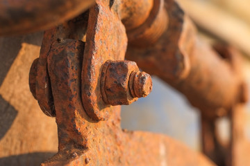 Orange rusty old bolts and nut made from steel close-up.