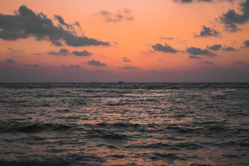 sunset sea view with orange sky and clouds