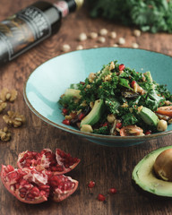 A Healthy Bowl of  Leafy Green Salad topped with slices of  fruits and nuts