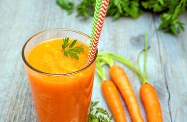 carrot juice in glass on wooden table