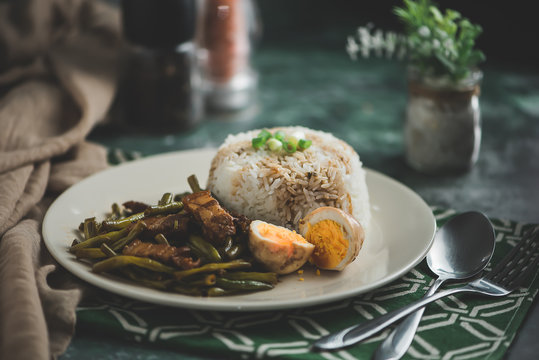 Adobong Sitaw is  a famous Filipino dish that can be served during lunch or dinner. The taste is on the sweet and sour side. Typically, its marinated in soy sauce and has pork bits and string beans.