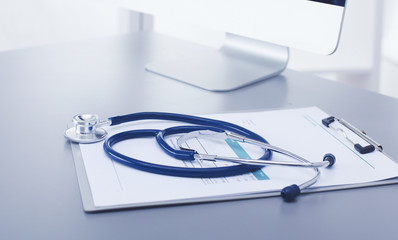 Medical equipment: blue stethoscope and tablet on white background. Medical equipment - obrazy, fototapety, plakaty