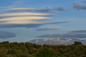 Huge white lenticular clouds over Sierra Nevada in Granada