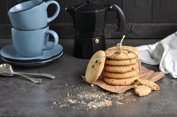 Tasty homemade cookies tied with rope near cups on grey table