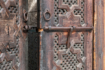 Old Moroccan, wooden door detail. Koranic school, Madrasa Bou Inania, Fes, Morocco