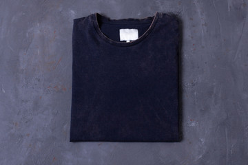 Basic navy Tshirt on grey concrete background. Mock up for branding t-shirt whith pocket. 