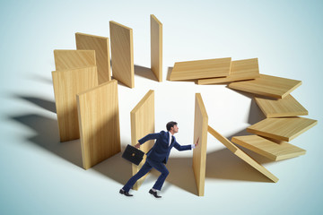 Businessman in domino effect concept