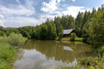 Fototapeta na wymiar house on the lake in forest
