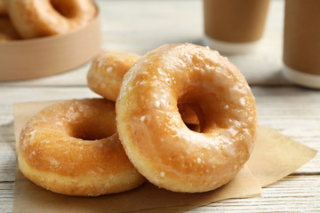 Delicious donuts on white wooden table, closeup