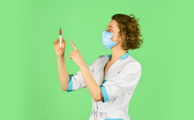 nurse wear respirator mask. Physician giving vaccine. HPV concept. Doctor with syringe is preparing...