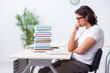 Young male student sitting in the classroom