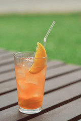 cocktail with orange juice and a slice of orange with a straw