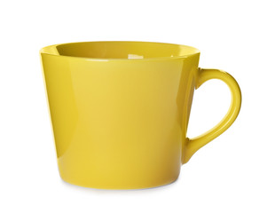 Beautiful yellow ceramic cup isolated on white