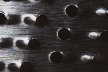 Grater with holes abstract background. metal grid with round cell close up
