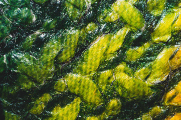 Green material close up background. crumpled cloth abstract texture