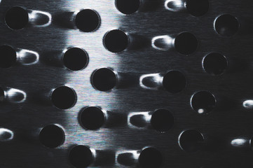 Grater with holes abstract background. metal grid with round cell close up