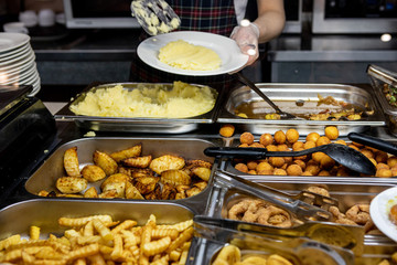 Potato dishes in a fast food restaurant. Fried vegetables