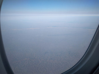 flying over the city in an airplane top view from the window on the wing on a trip tourists