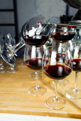 Wine glasses with red wine on wooden table