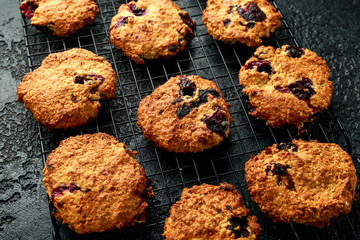 Home made Blueberry and walnut oat cookies on black background