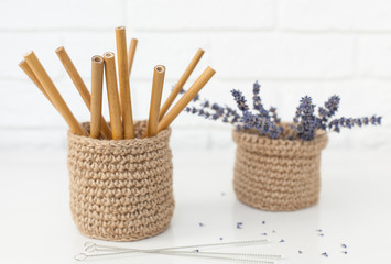 reusable bamboo cans for drinks in a jute basket with lavender in the background, preserve nature without plastic. horizontal frame with place for test