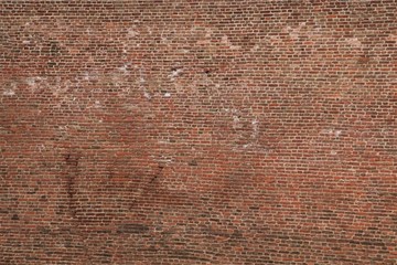 Old wall of bricks of different sizes and colors.
