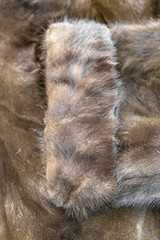 Textured surface of a brown coat made of natural mink fur
