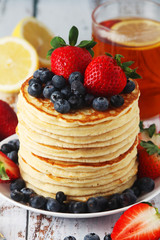 A stack if home-made pancakes with berry