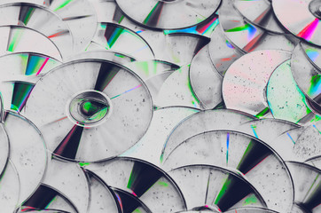 Group of old CD DVD compact optical disk storage medium with dust and scratches. Abstract grunge...