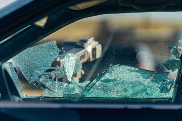 An EOD Bomb Robot shatters a window for a bomb technician to make entry