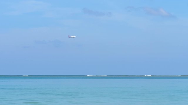 Airplane approaching over ocean