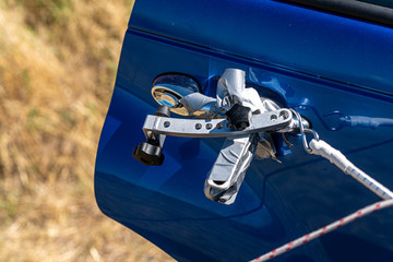 A hinged tool used to open car doors remotely
